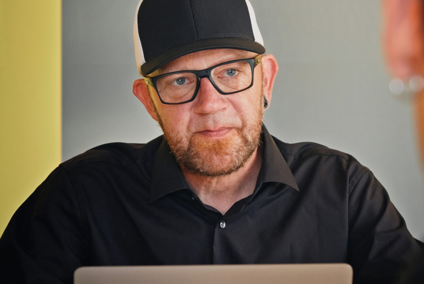 Mitarbeiter von seitenweise arbeitet in einer Besprechung am Laptop