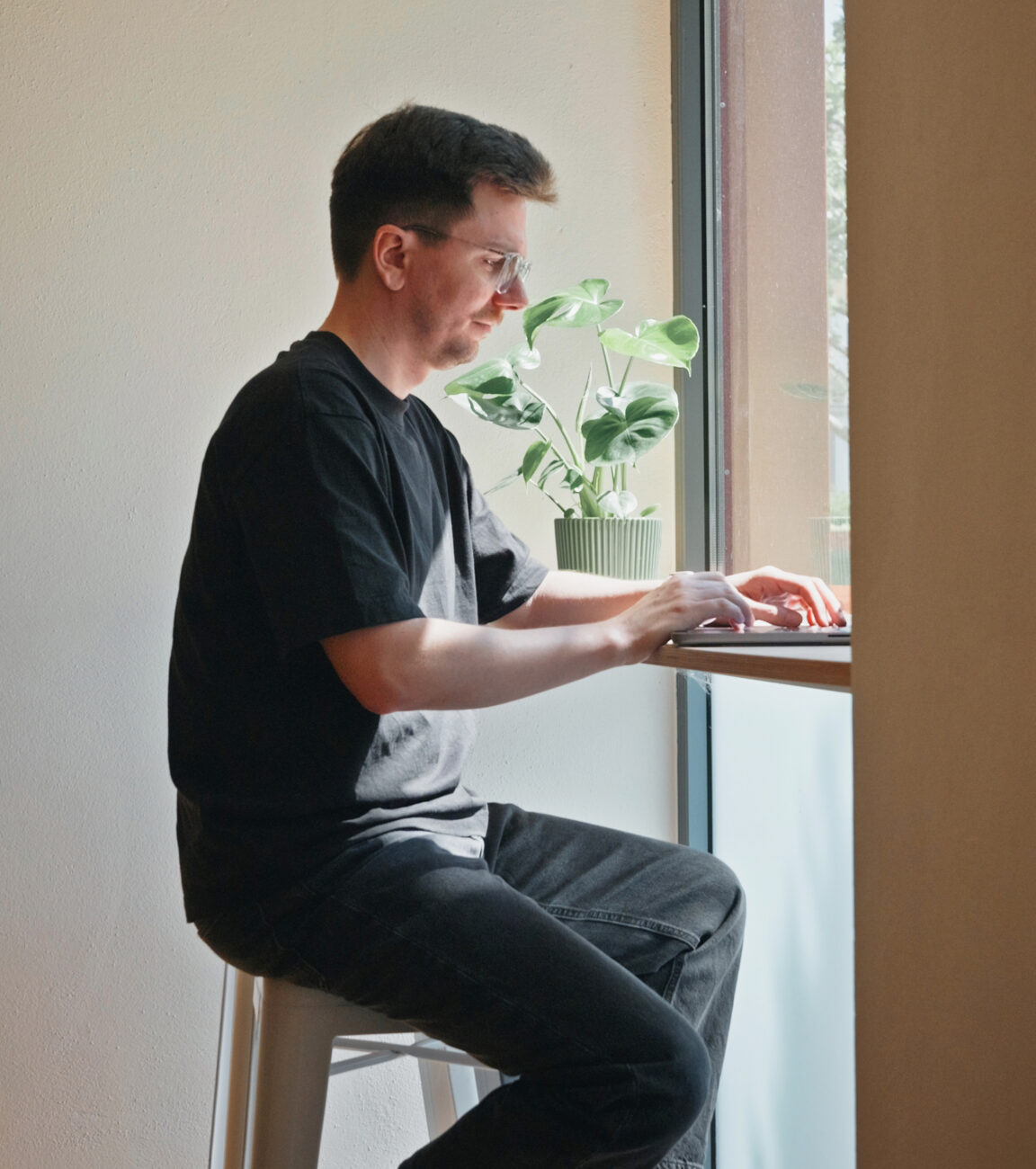 Mitarbeiter von seitenweise arbeitet im Stehen am Laptop